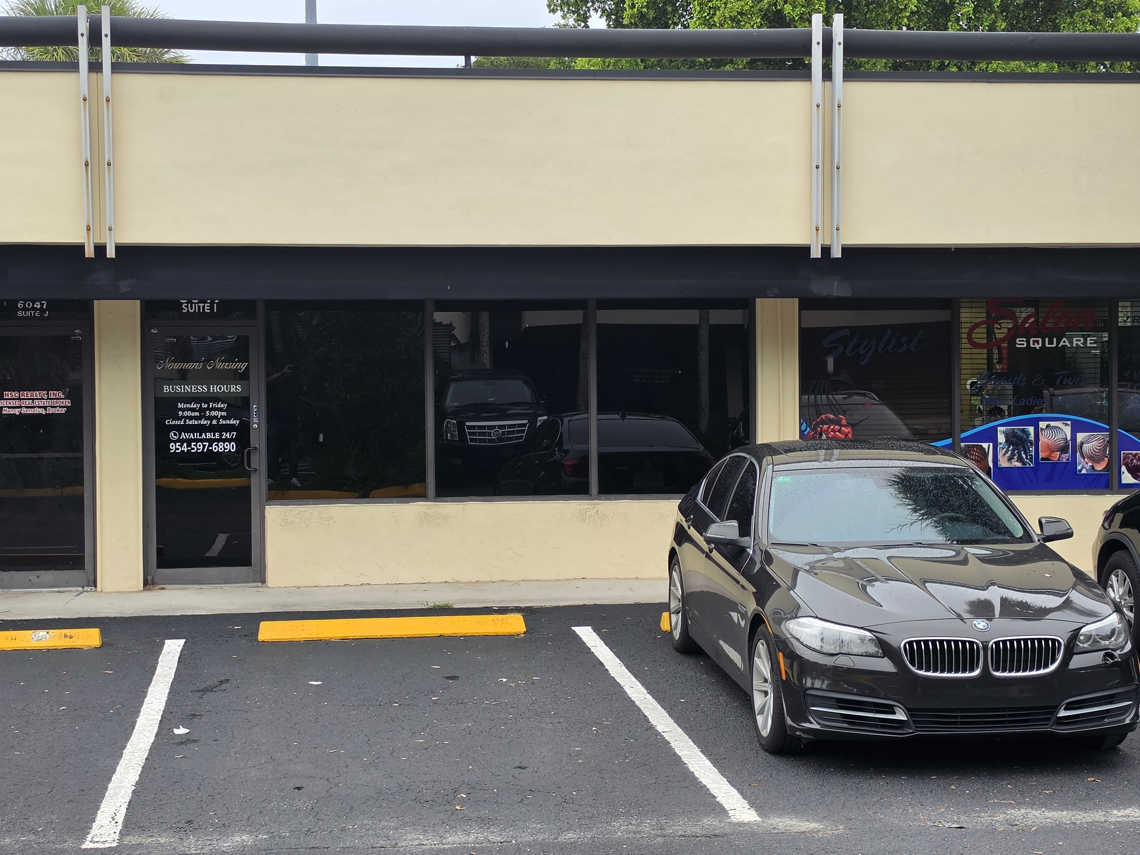 A low Florida office building with palm trees.